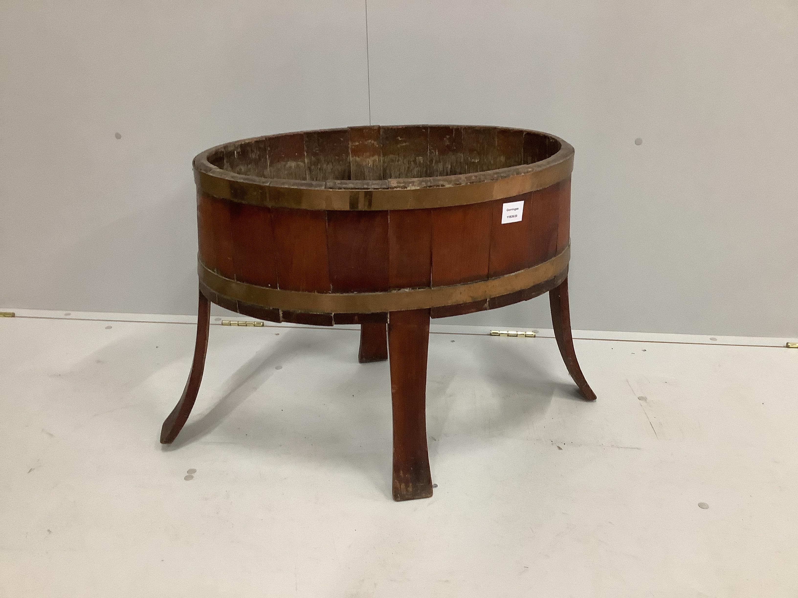 A George III oval brass bound mahogany wine cooler, lacking base and liner, width 75cm, depth 45cm, height 54cm